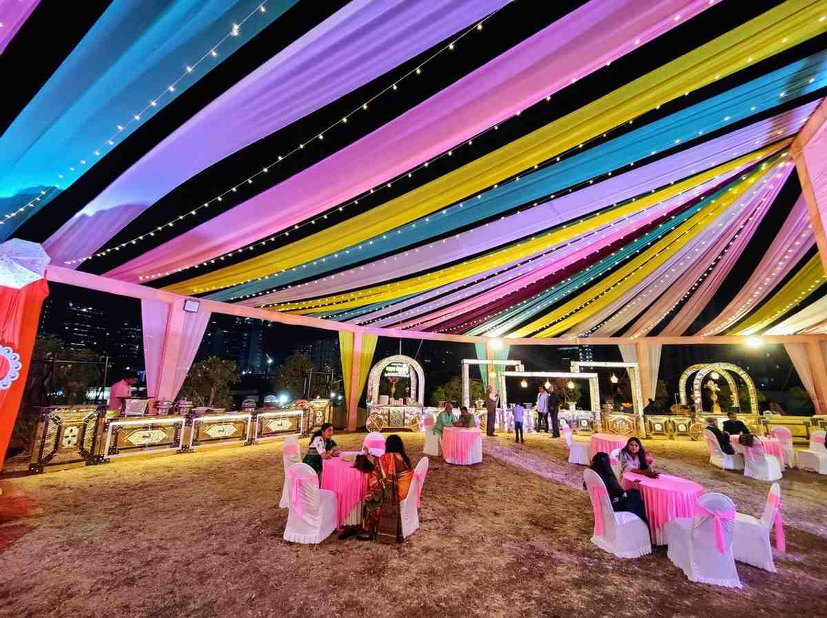 Colourful draped canopy with fairy lights and decorated wedding lawn setup at Kapila Resorts Kharadi Pune